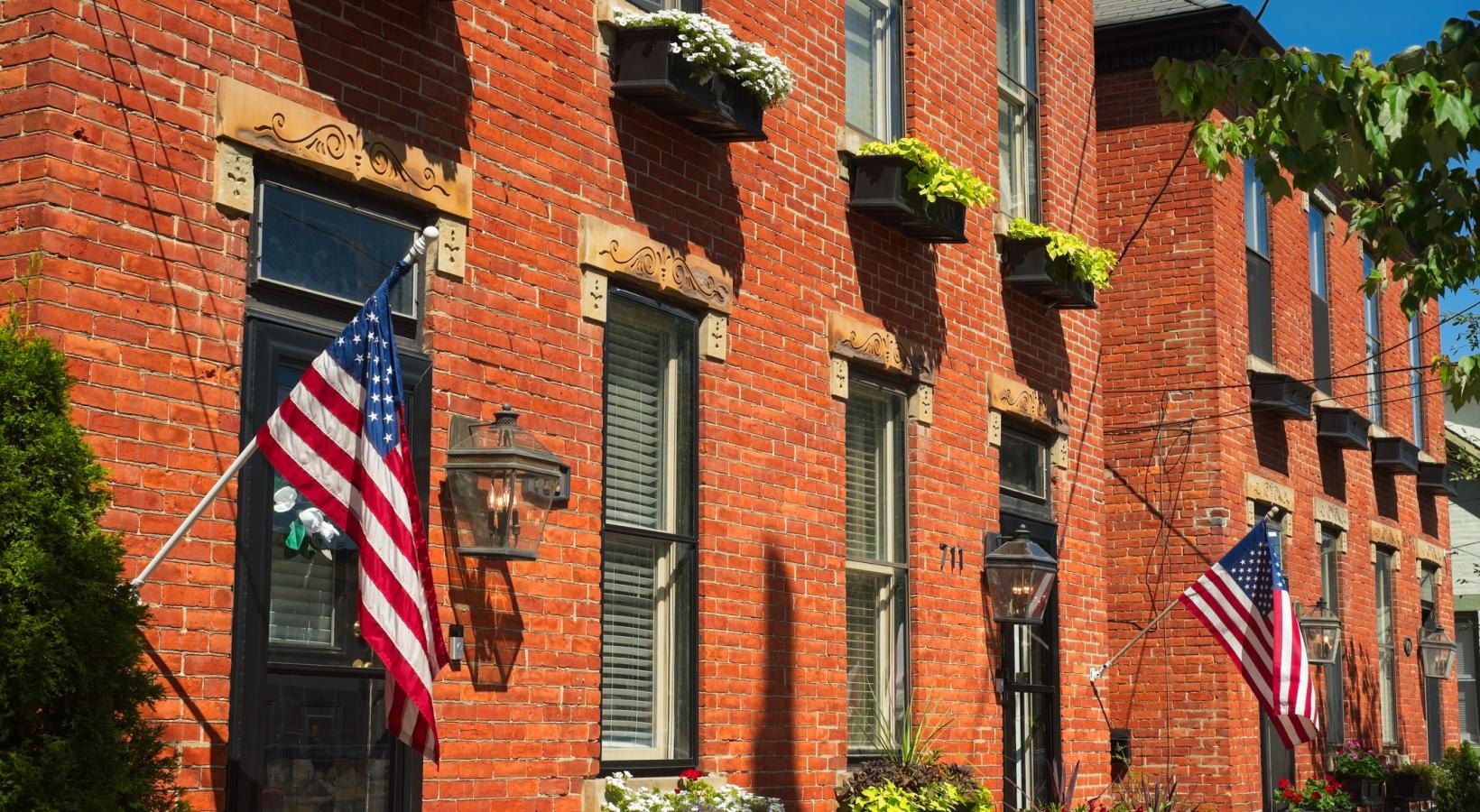 Find your perfect fit at Saw Mill Village a flag on a brick building