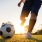 a person kicking a soccer ball
