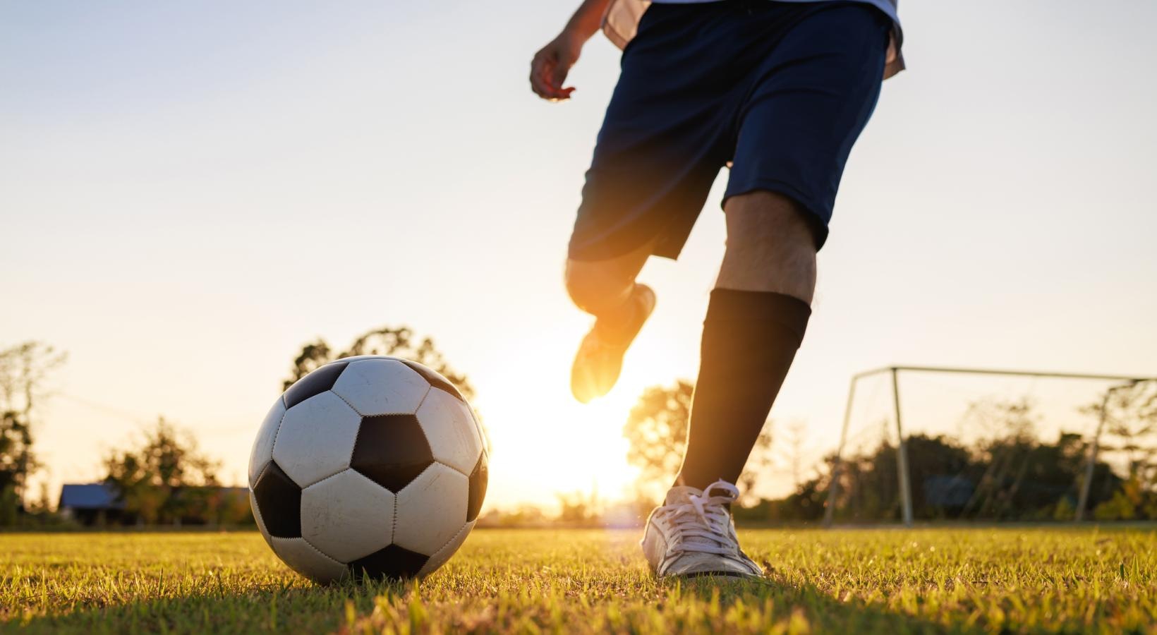 The essence of exceptional living a person kicking a soccer ball