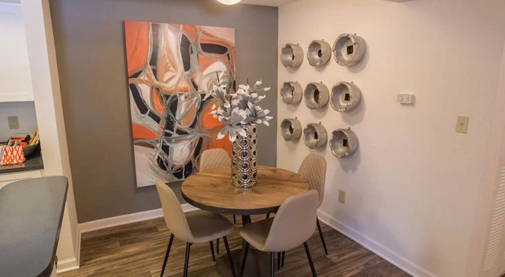Gorgeous living areas to entertain and enjoy a table with chairs and a vase with flowers on it