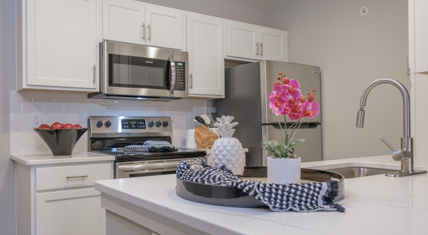 Beautiful kitchens with designer finishes a kitchen with white cabinets and a white counter top