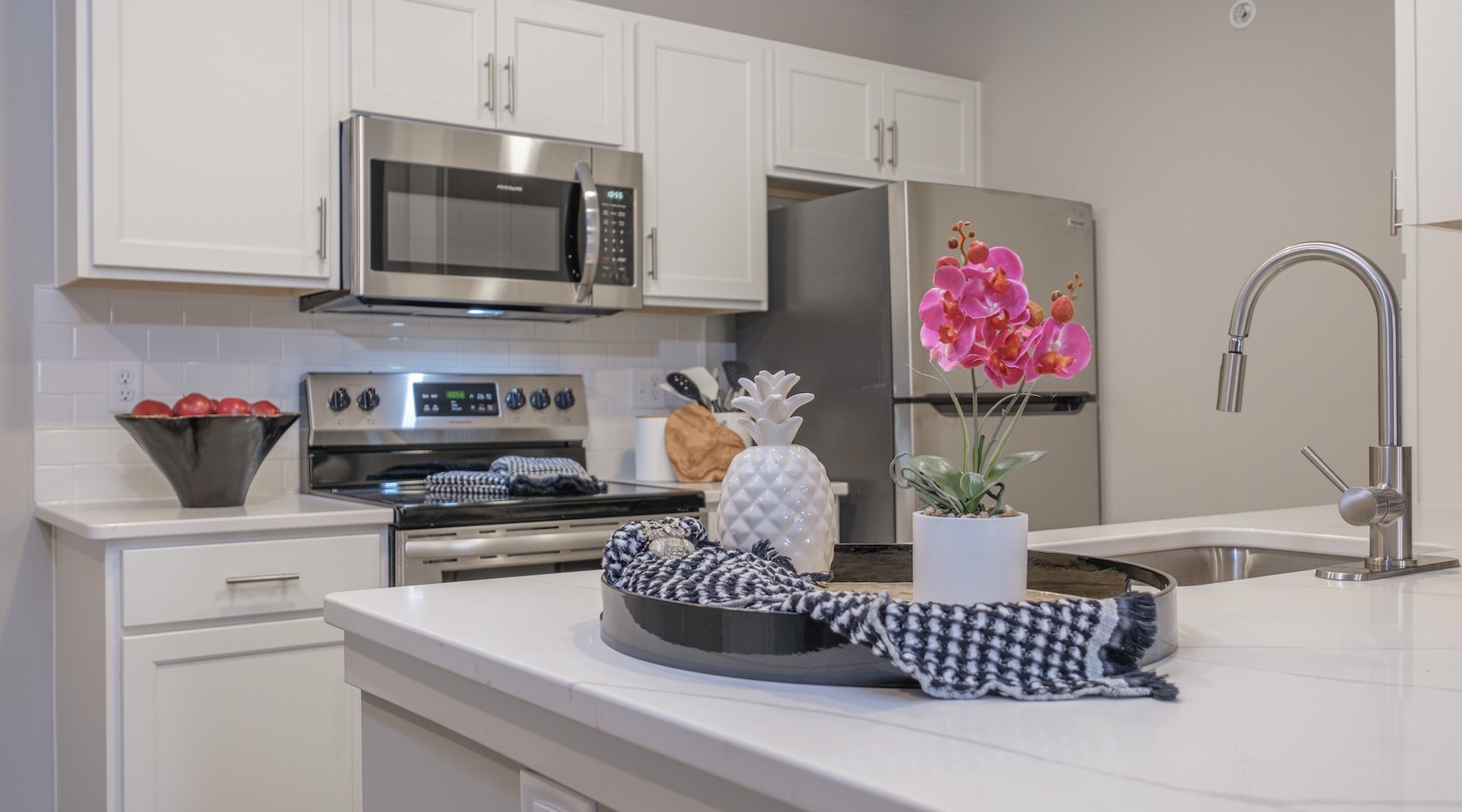 Spacious kitchens with thoughtful details kitchen with sink and counter with flowers on a table