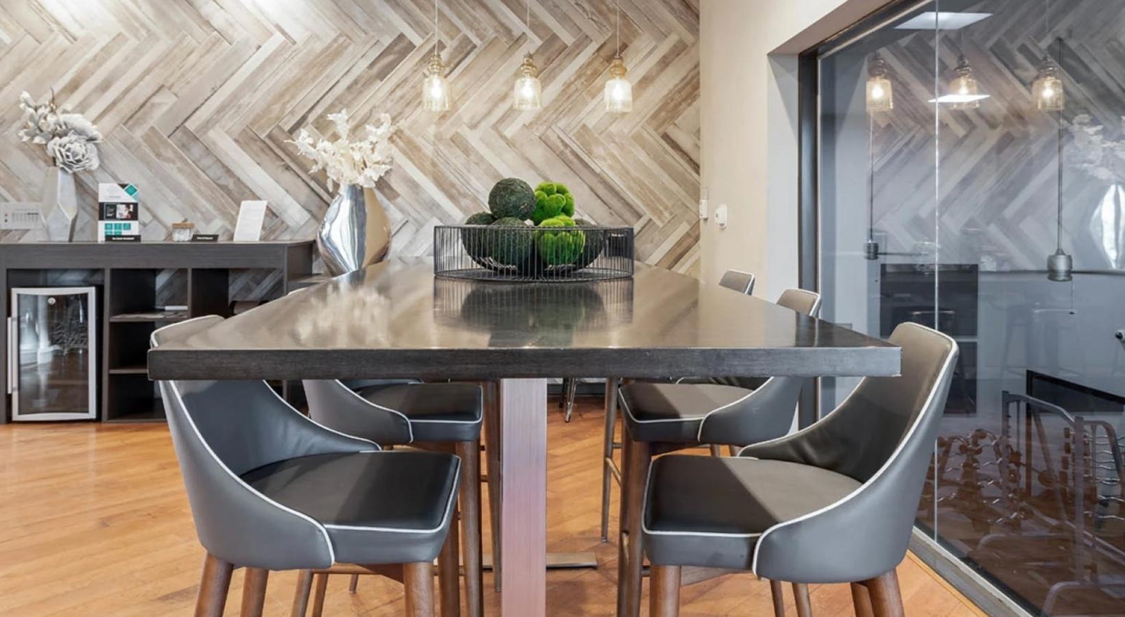 Settle into comfort at Saw Mill Village a large table with chairs around it