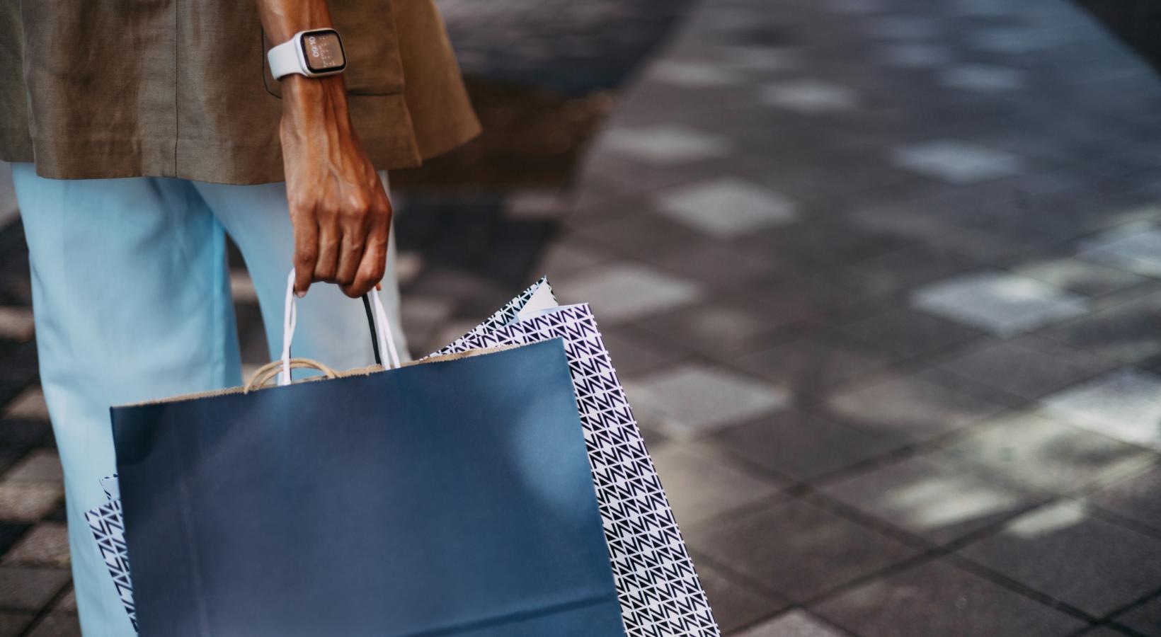 Find your perfect fit at Saw Mill Village a person holding a few bags