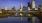 a city skyline with a bridge over a body of water