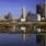 a city skyline with a bridge over a body of water