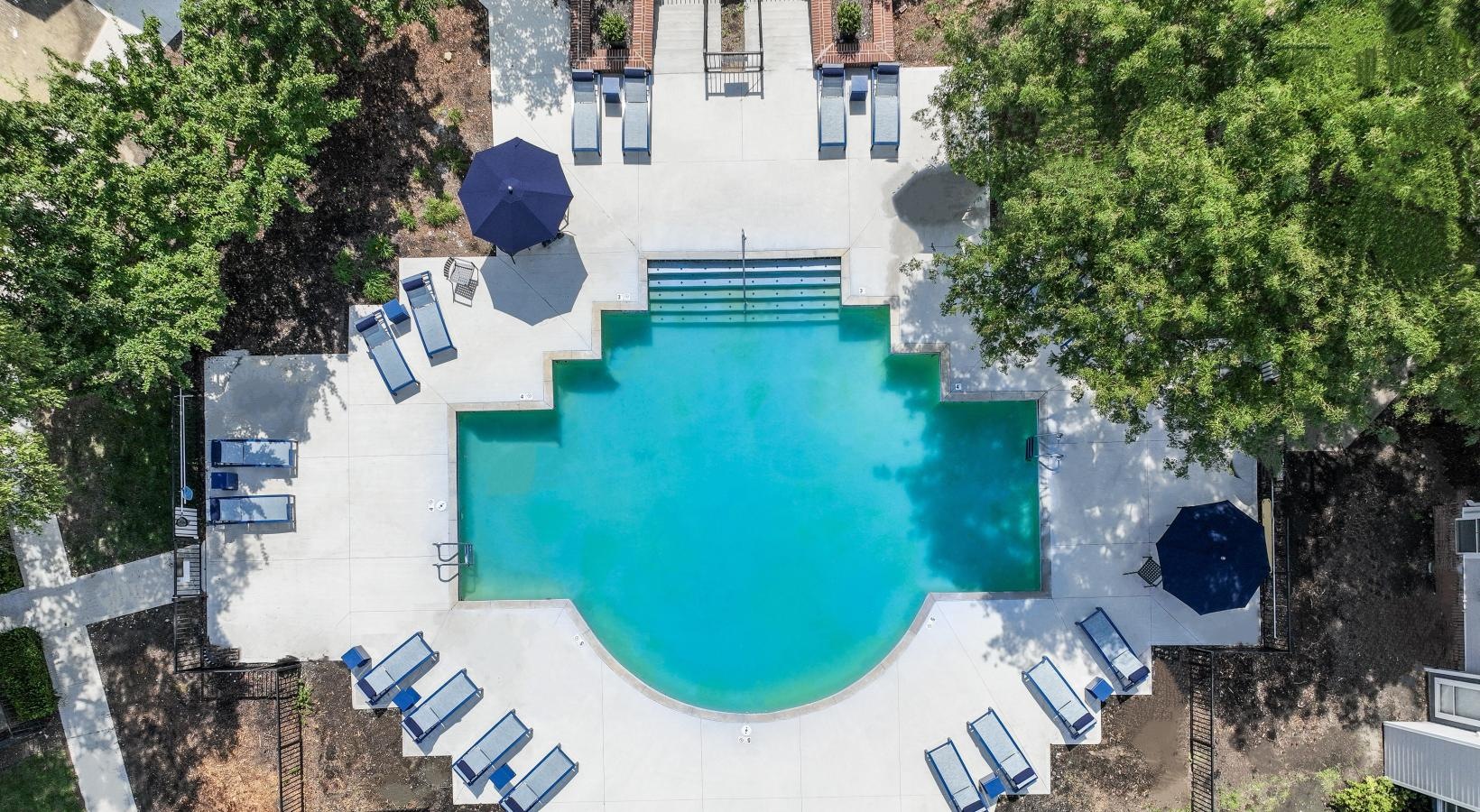 Relax and unwind poolside a pool in a courtyard
