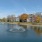 a body of water with apartments along it