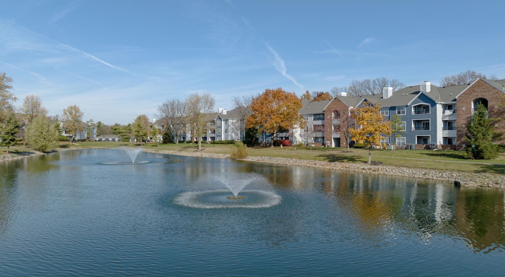 Find your perfect fit at Saw Mill Village a body of water with apartments along it