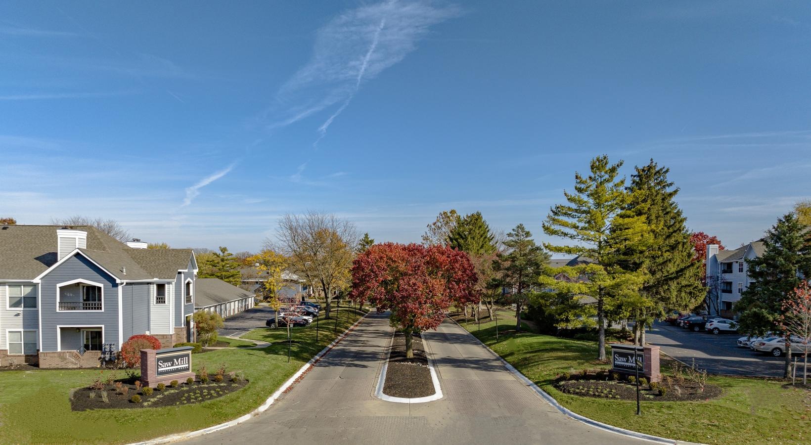Settle into comfort at Saw Mill Village a road with trees and buildings along it