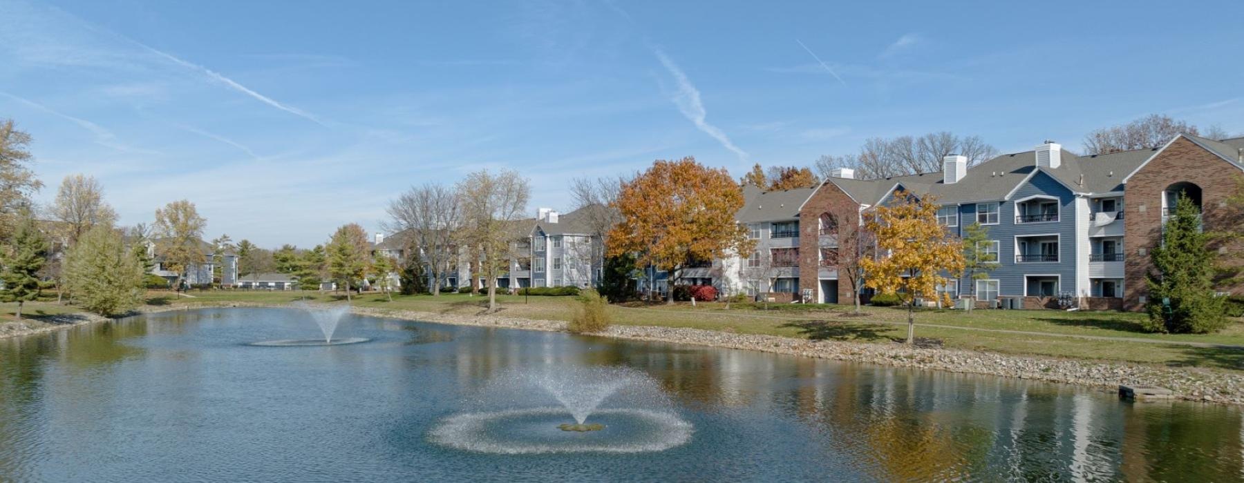 a body of water with apartments along it